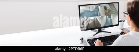 Person Watching CCTV Footage On Computer Screen Stock Photo