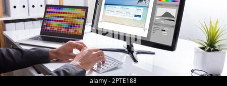 Graphic Web Designer Printing Photo On Computer Stock Photo