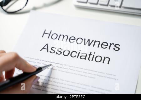 Person Reading HOA Rules And Regulations Document Stock Photo