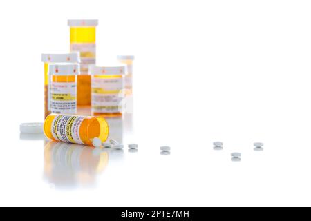 Non-Proprietary Medicine Prescription Bottles and Spilled Pills Isolated on a White Background. Stock Photo