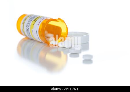 Non-Proprietary Medicine Prescription Bottle and Spilled Pills Isolated on a White Background. Stock Photo