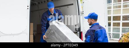 Furniture Mover Unloading Truck. Relocation Delivery Load Stock Photo