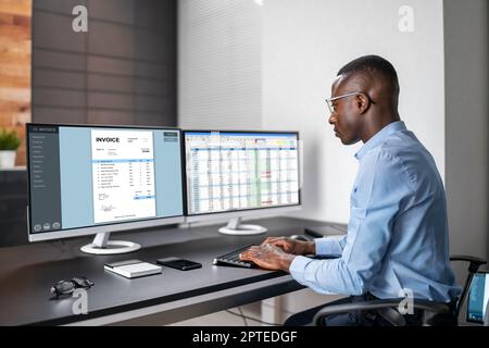 African American Accountant Using Electronic Invoice Software Stock Photo