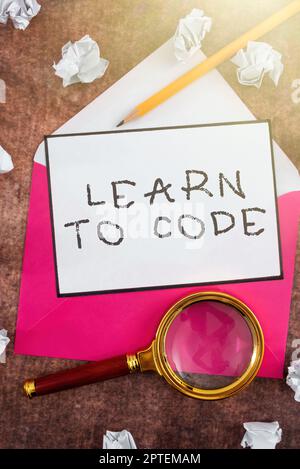 Writing displaying text Learn To Code, Internet Concept Learn to write Software Be a Computer Programmer Coder Stock Photo