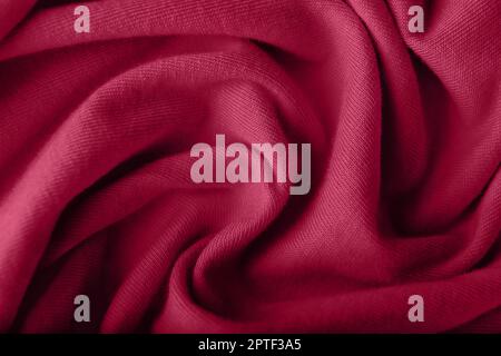 Crumpled knitted viva magenta fabric, closeup Stock Photo