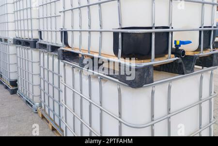 Lots of cube water tanks. 1000 litres containers piled outdoors Stock Photo