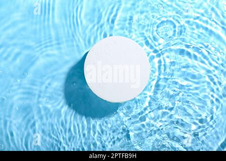 Decorative plaster podium in water on blue background Stock Photo