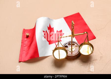 Flag of Canada with justice scales on beige background Stock Photo