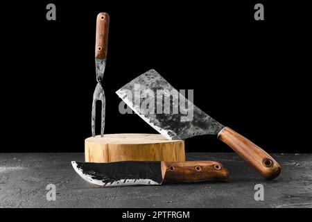Forged butcher set on black background Stock Photo