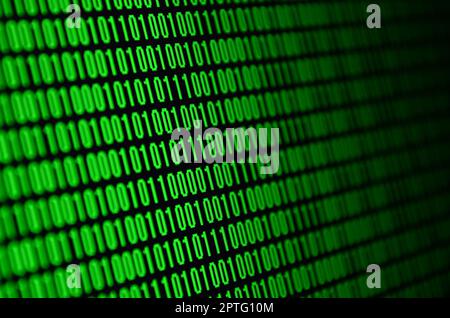 An image of a binary code made up of a set of green digits on a black background Stock Photo