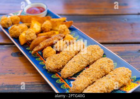 Fry fish finger and potato wedges Stock Photo