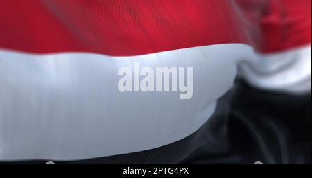 Close-up view of the Yemen national flag waving. The Republic of Yemen is a state located in Western Asia. Fabric textured background. Selective focus Stock Photo