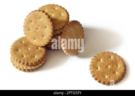 Classic round golden yellow salted cracker isolated on over white background Stock Photo