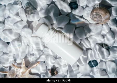 White beauty product roll on antiperspirant deodorant anti sweat smell, vial in transparent fresh water with flecks and waves above bottom of white st Stock Photo