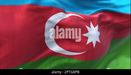 Close-up view of the Azerbaijan national flag waving in the wind. Azerbaijan is a country located at the boundary of Europe and Asia. Fabric textured Stock Photo