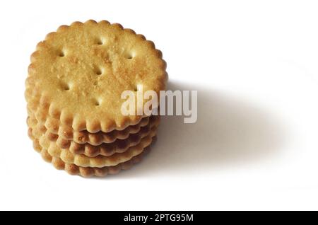 Classic round golden yellow salted cracker isolated on over white background Stock Photo