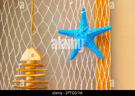 Starfish blue on the white mesh background Stock Photo