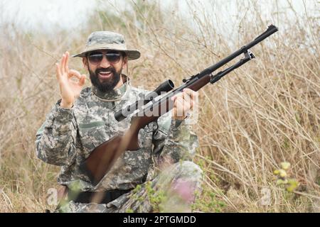 Camouflaged Hunter In Jungle Like Area With Sniper Rifle , He Must Blend  Into Surrounding To Not Be Detected Stock Photo, Picture and Royalty Free  Image. Image 67250301.