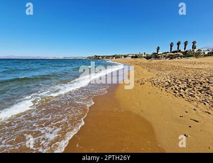 Beautiful Stalos sandy beach with crystal clear sea in Chania prefecture, Crete, Greece. Stock Photo