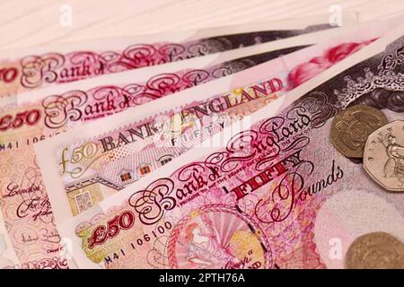 UK money bills and coins close up. Big amount of United Kingdom pounds and small coins on table. Business and stock concept for England Stock Photo