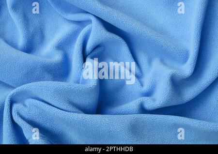 The blanket of furry blue fleece fabric. A background of light