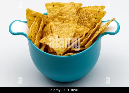 Nachos in a plastic bowl. Tortilla chips isolated on white background. Stock Photo