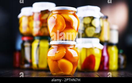 Jars with variety of marinated vegetables and fruits. Preserved food Stock Photo