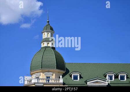 Completed perfect high-quality roofing work from metal roofing. The dome of a polyhedral shape with a spire is covered with green metal tiles Stock Photo