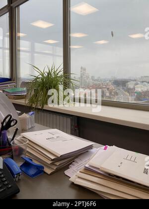 Large thick folders with important papers and documents on the working office desk. Stock Photo