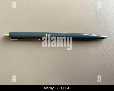 Automatic green ballpoint pen for writing on your desktop office desk. Business work. Stock Photo