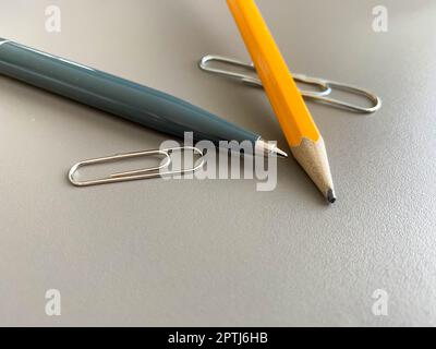 Automatic green ballpoint pen and pencil with paper clips for writing on your desktop office desk. Business work. Stock Photo