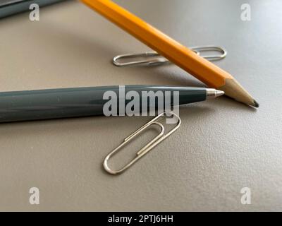 Automatic green ballpoint pen and pencil with paper clips for writing on your desktop office desk. Business work. Stock Photo
