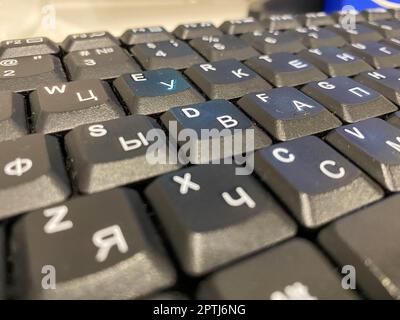 Close-up view of a black plastic keyboard with buttons on a work computer in a business office. Stock Photo