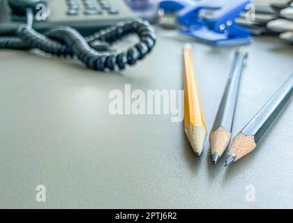 office supplies for writing. on the table at the worker are folded pencils for working with papers. simple pencil without color for office work. Stock Photo