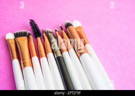 A set of beautiful different soft brushes for make-up from natural nap for beauty targeting and applying a tonal foundation in a stand and copy space Stock Photo