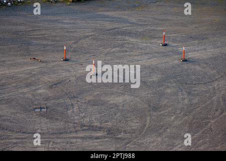 Orange traffic bollards on a gravel area Stock Photo