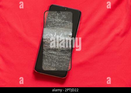 mobile phone and broken tempered glass on an isolated background, glass replacement Stock Photo