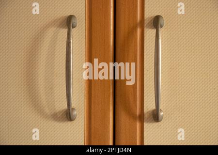 brown kitchen cabinet door handles in the kitchen Stock Photo