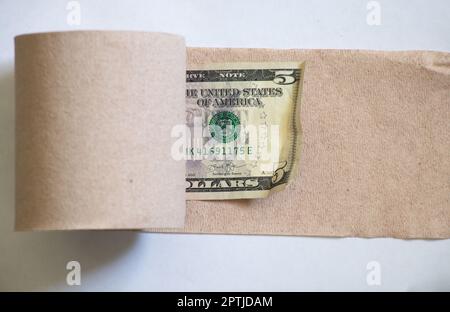 one american dollar roll up toilet paper roll on white background Stock Photo