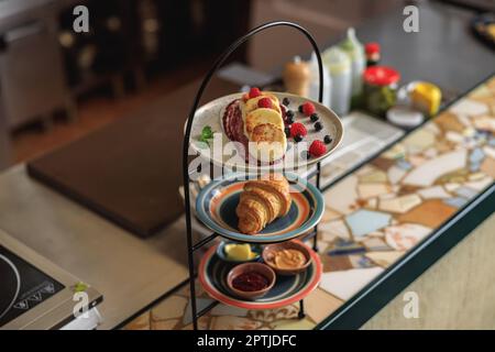 Tray with breakfast at ordering station in open restaurant kitchen Stock Photo