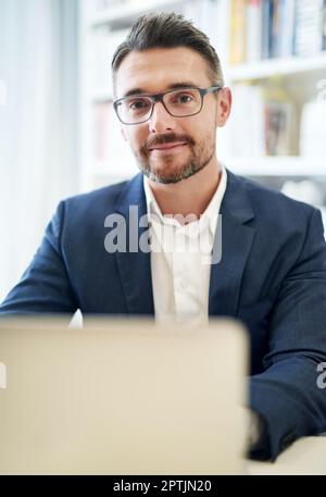 Tackling his work with a can-do attitude. Cropped portrait of a businessman working in his office Stock Photo