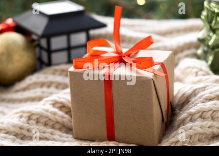 Christmas gift box. Xmas and Happy New Year background, close up. Gift with red ribbon. Celebrating Christmas Stock Photo