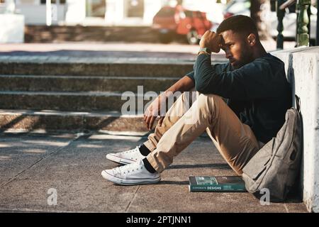 Education, fail and stress with a black man student worried about an exam or test on university campus. College, sad and scholarship with a male pupil Stock Photo