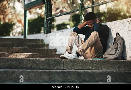Mental health, depression and anxiety with student on stairs with backpack for failure, fear and mistake. Sad, stress or bullying with black man on st Stock Photo