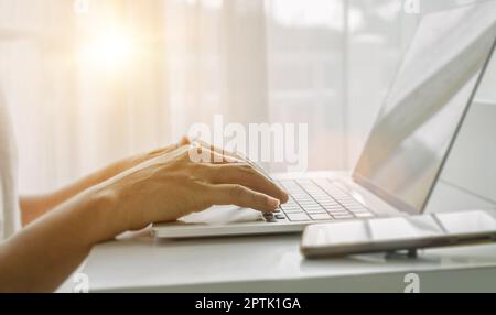 Close up of man hands using laptop at home office. Concept of searching web, browsing information. soft focus Stock Photo