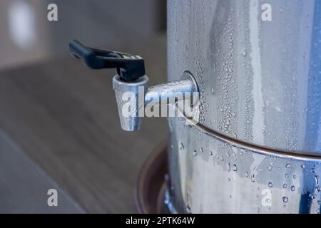 Cooler water in tank stainless steel and steam Stock Photo