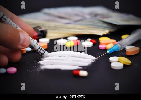 drugs addiction sniffing through a bill Stock Photo