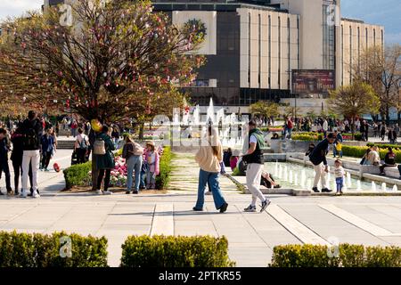 People enjoying the fine weather at the fountains of the iconic building of the National Palace of Culture or NDK in Sofia, Bulgaria, Eastern Europe Stock Photo