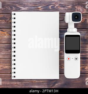 Pocket Handheld Gimbal Action Camera with Blank Note Pad on a plank wooden  table background. 3d Rendering Stock Photo