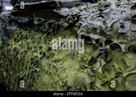 Armoured military vehicle camouflage cover - tarpaulin mesh, closeup detail Stock Photo
